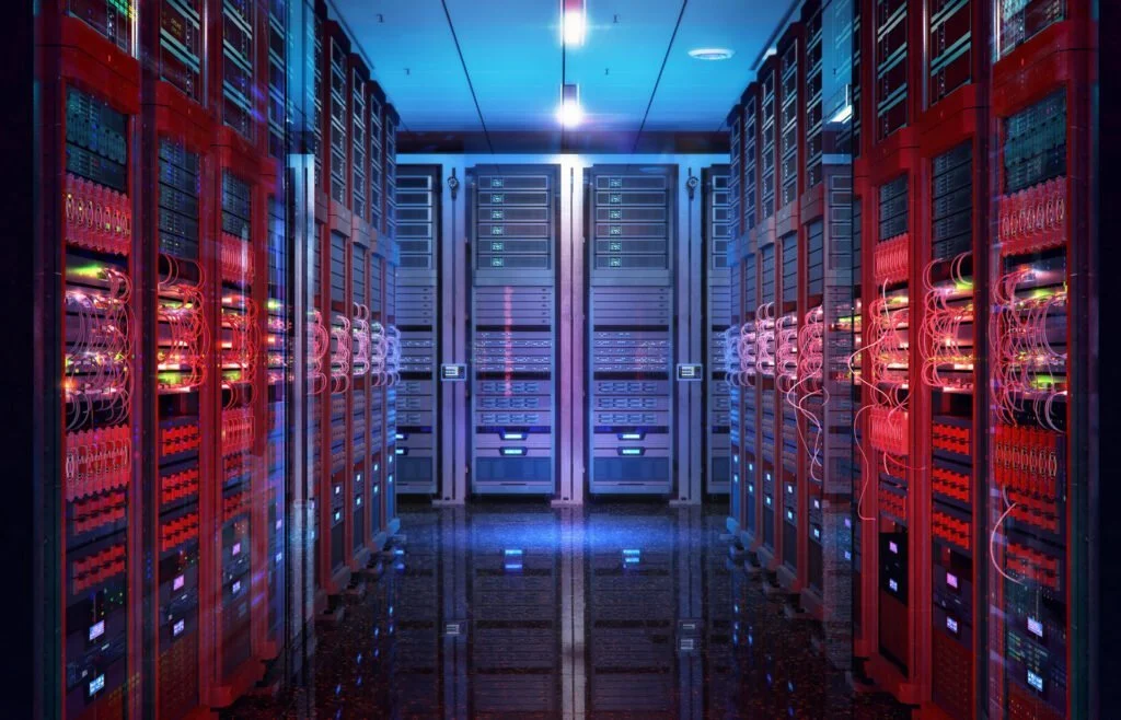 A modern, illuminated data center with rows of high-performance servers and complex network cables reflecting blue and red lights.
