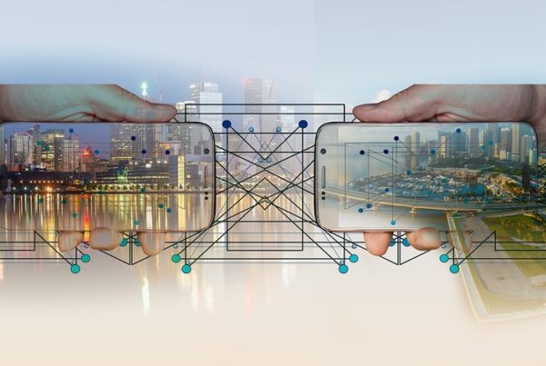 Collage of urban cityscapes on mobile screens managed by cloud technology, held by hands connected by network grid lines, symbolizing digital connectivity and infrastructure.