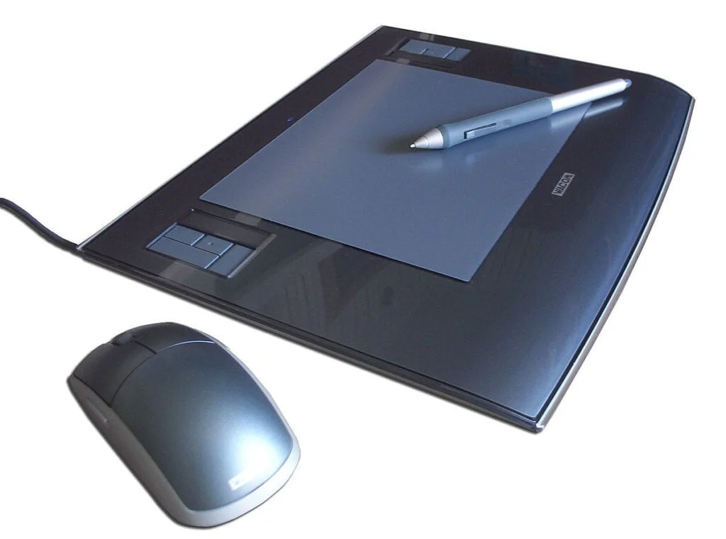 A graphics tablet with a stylus and a wireless mouse on a white background.
