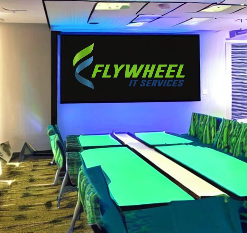 A modern conference room with green and blue lighting, featuring AV solutions for business and a large screen displaying the logo of "flywheel it services.